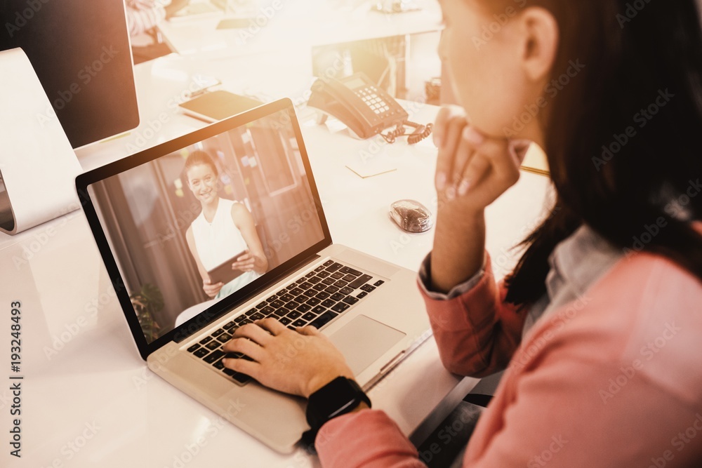 Composite image of woman working on laptop at office Composite image of woman working on laptop at office