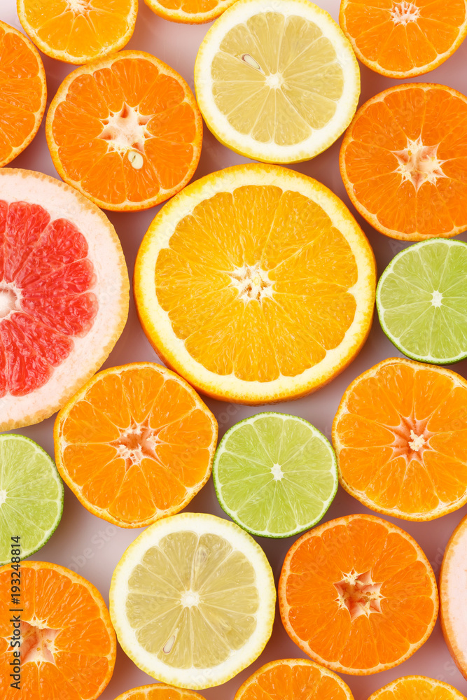 Citrus fruits background mix flat lay. Texture of sliced citrus closeup view.