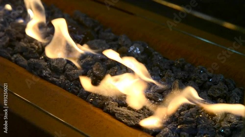 Modern bio fireplot fireplace on ethanol gas close-up. Stones fire flame photo