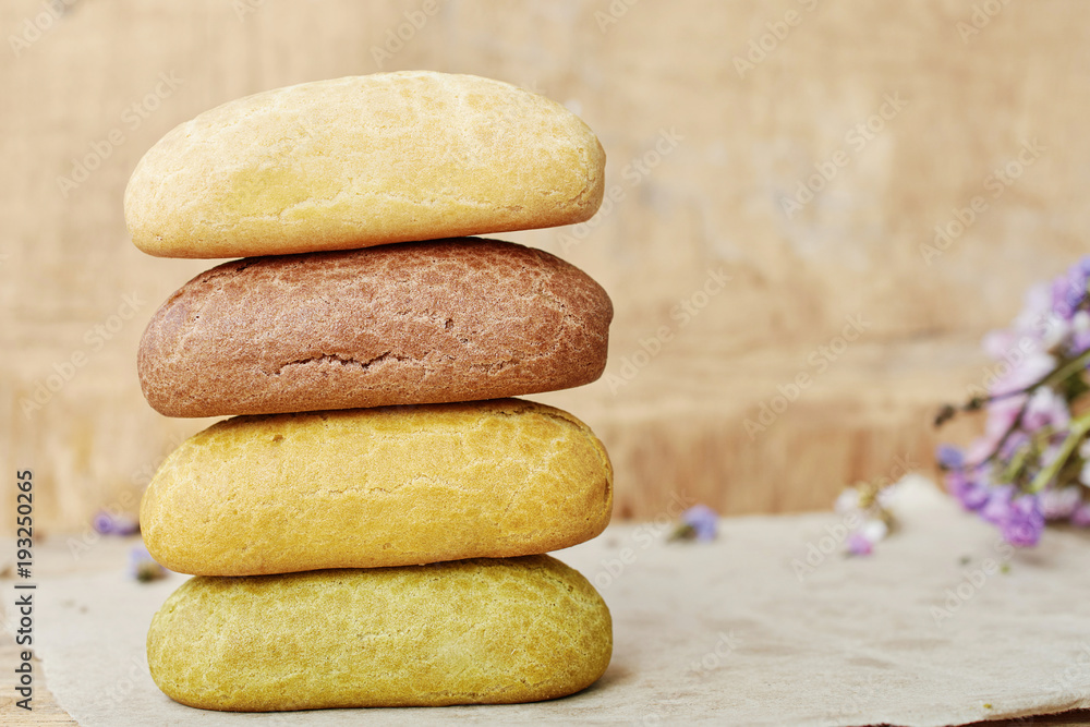 Close up of assorted homemade eclairs over wooden background. Soft focus. Close up of assorted homemade eclairs over wooden background. Soft focus.