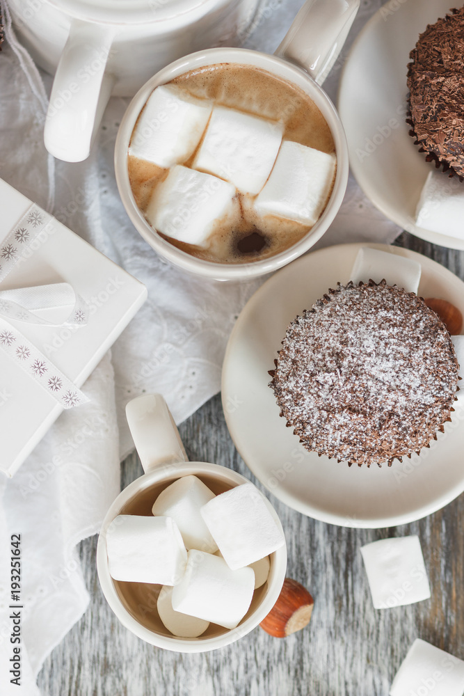 Cups with cacao and marshmallow, cupcakes and different decorations Cups with cacao and marshmallow, cupcakes and different decorations