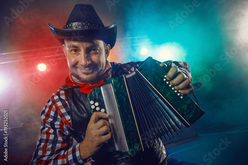 The actor plays the accordion. photo