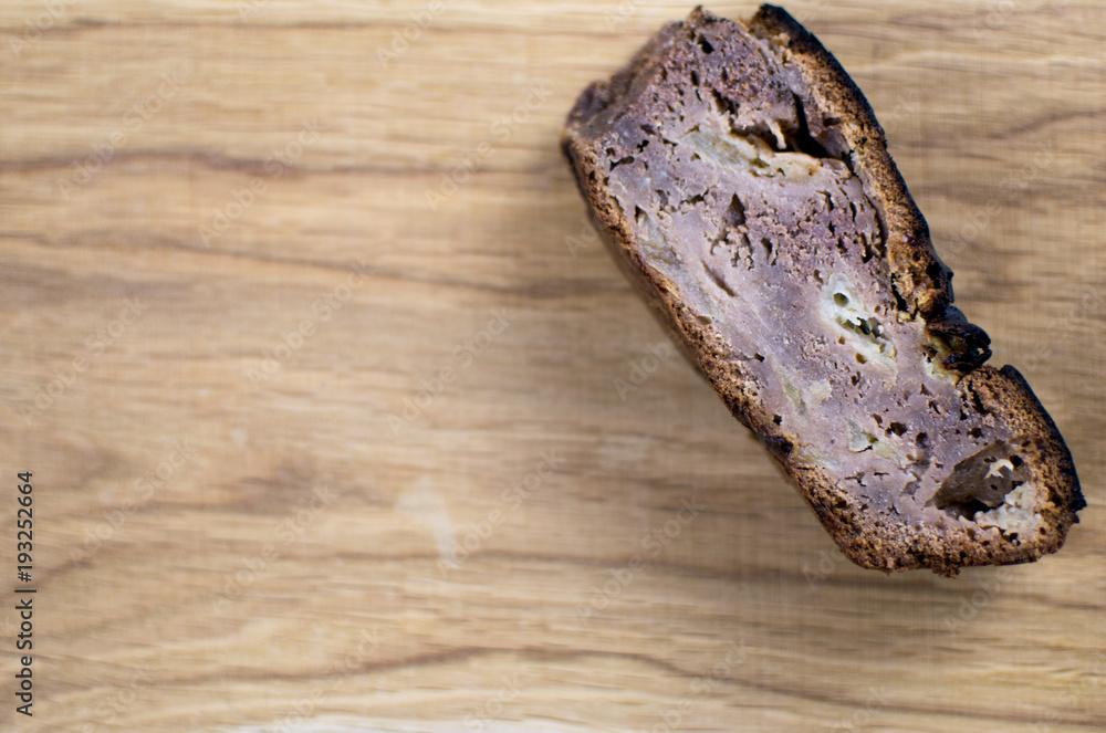 A piece of homemade pie on a wooden background. A piece of homemade pie on a wooden background.