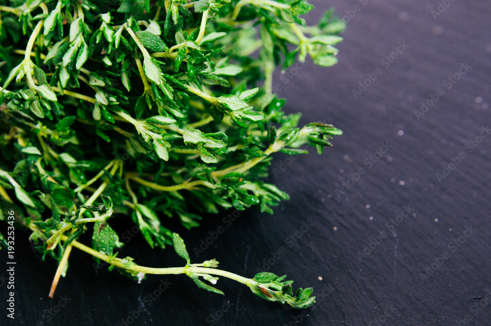 Bunch of fresh thyme on a black background. Top view image. Copyspace for your text Bunch of fresh thyme on a black background. Top view image. Copyspace for your text