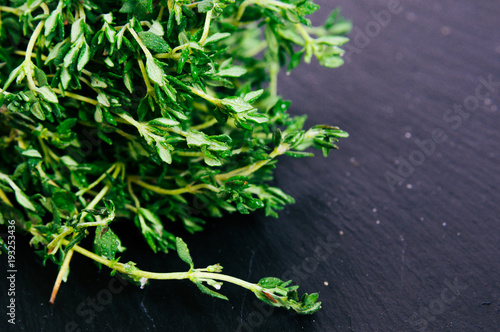 Bunch of fresh thyme on a black background. Top view image. Copyspace for your text