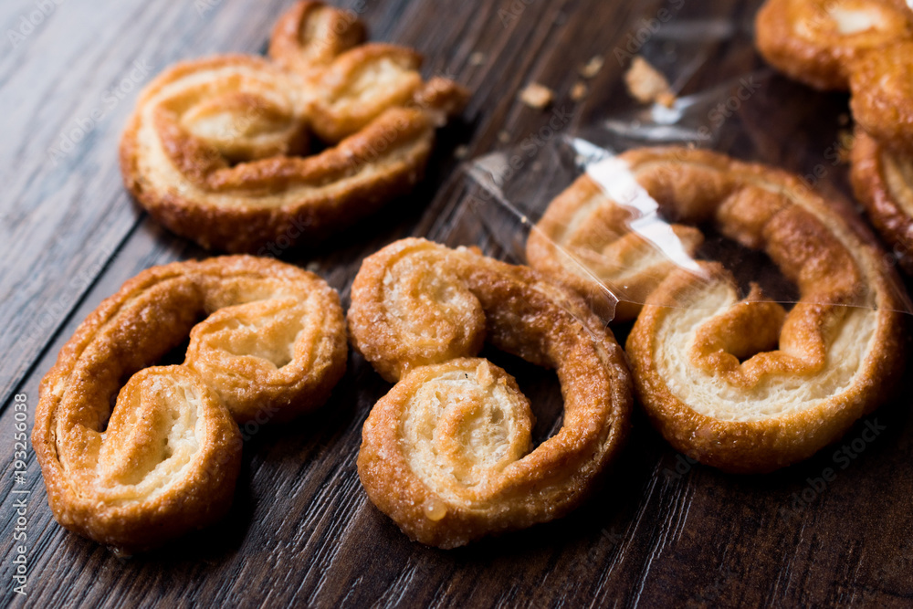 Palmier Cookies in Black Plate on Wooden Surface. Palmier Cookies in Black Plate on Wooden Surface.