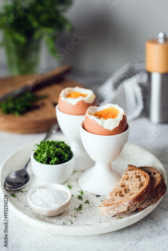 Breakfast with boiled eggs and toasted bread. Vertical, selective focus