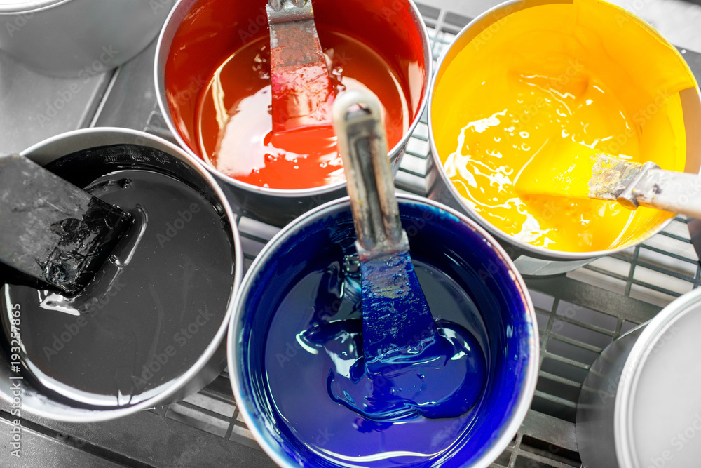 Four open buckets with CMYK paints at the printing manufacturing - obrazy, fototapety, plakaty 