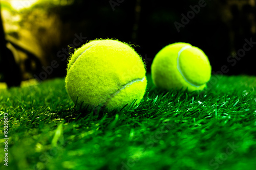Tennis ball on artificial grass © Jiranat-K