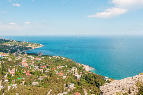 Beach at the seaside, blue water, view from above the mountains to the town of Simeiz, Yalta, Crimea