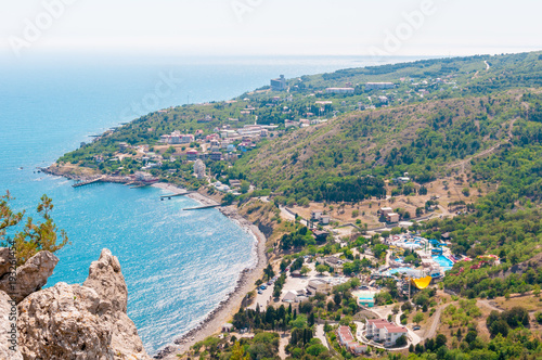 Beach at the seaside, blue water, view from above the mountains to the town of Simeiz, Yalta, Crimea © Irina Sokolovskaya
