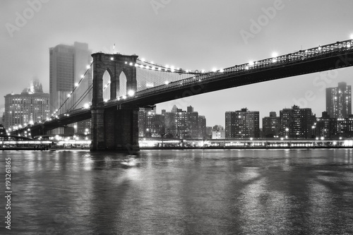 Brooklyn Bridge and the Manhattan on a foggy night  New York City  USA.