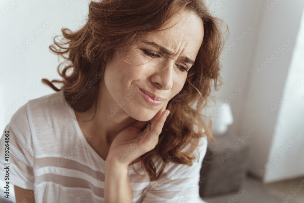 Need to take some pills. Portrait of poor young lady touching her cheek while feeling some discomfort in a tooth area. Need to take some pills. Portrait of poor young lady touching her cheek while feeling some discomfort in a tooth area.
