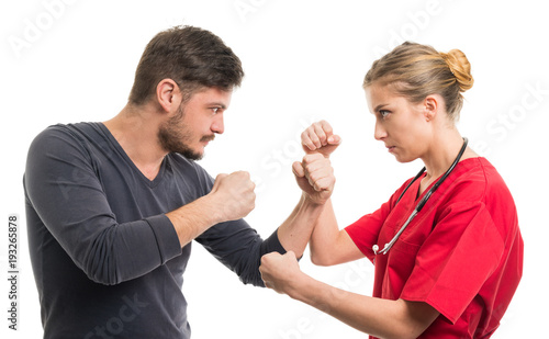Lady doctor and male patient in fighting position.