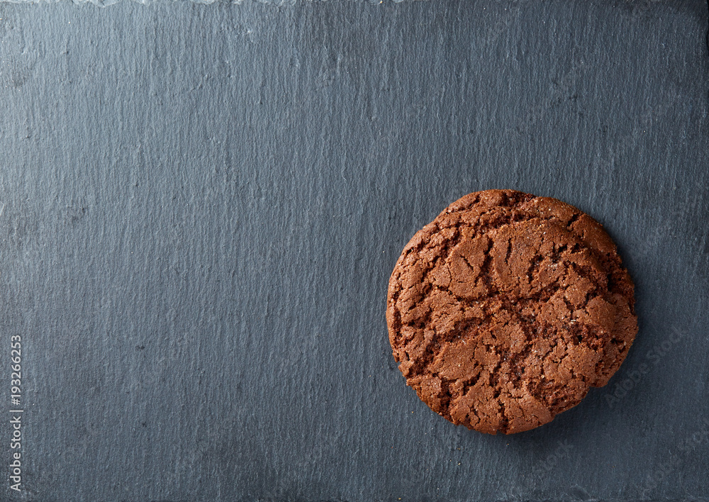 Lowkey picture of two chocolate cookies on dark background, close-up, shallow depth of field Lowkey picture of two chocolate cookies on dark background, close-up, shallow depth of field