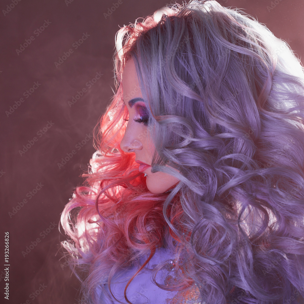 Fototapeta premium Beautiful woman with bright hair. Bright hair color, hairstyle with curls.