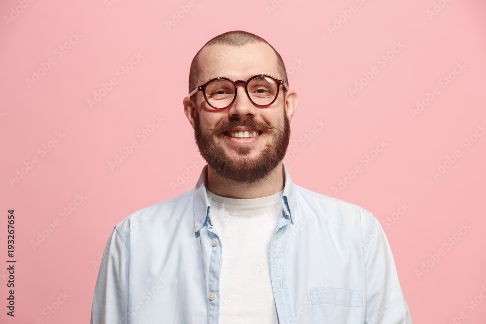The happy business man standing and smiling against pastel background. The happy business man standing and smiling against pastel background.