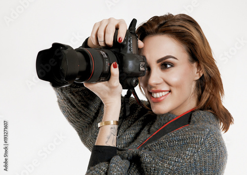 Wallpaper Mural Pretty Young smiling girl taking a photo with a professional DSLR camera Torontodigital.ca