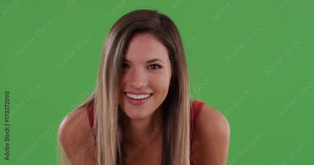 Pretty millennial woman smiling and blowing kisses to camera on greenscreen. Happy laughing Caucasian girl in her 20s with hands on knees making eye contact. 4k on green for keying or compositing Pretty millennial woman smiling and blowing kisses to camera on greenscreen. Happy laughing Caucasian girl in her 20s with hands on knees making eye contact. 4k on green for keying or compositing