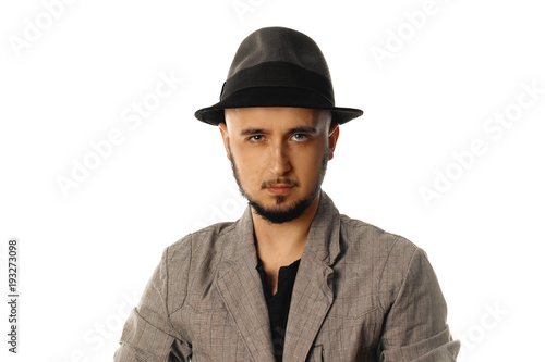 Gorgeous young man in hat and jacket looking at the camera