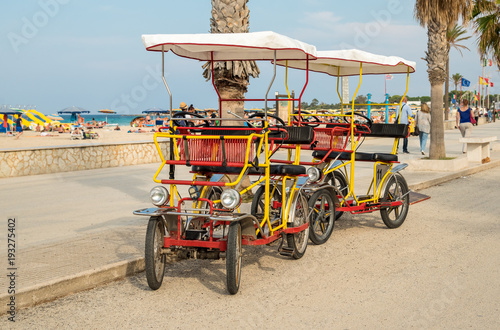 Rickshaw bicycle for rental for tourists parked near beach in San Vito Lo Capo, Sicily
