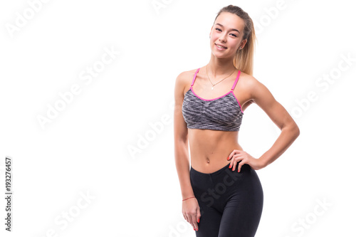 Portrait of a beautiful sports woman with hands on hips on white background © F8  \ Suport Ukraine