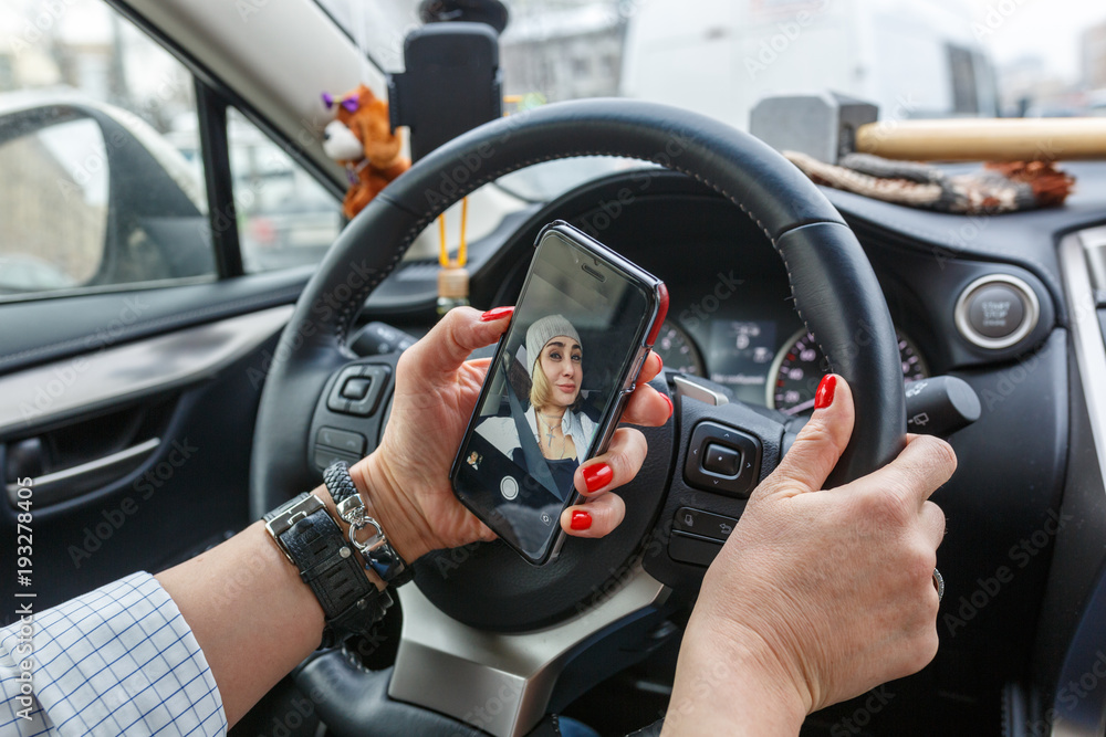 Women is making a selfie while driving Women is making a selfie while driving