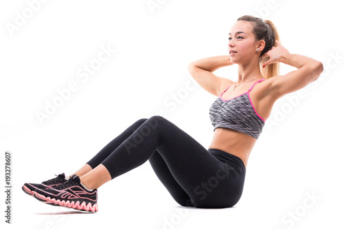Portrait of young happy smiling blond woman doing exercise abdominal crunches, pumping press, isolated over white background