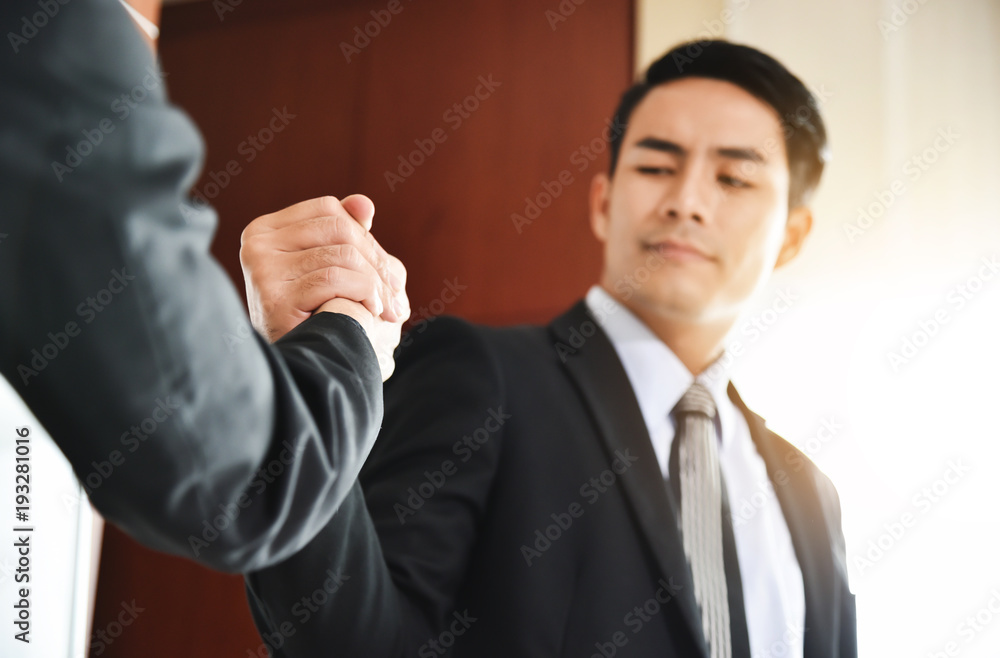 Asian Business people Handshake at meeting.