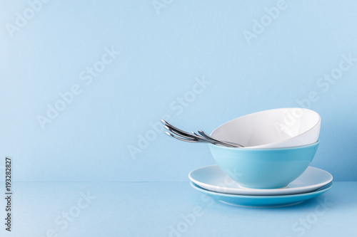 Crockery and cutlery on a blue pastel background