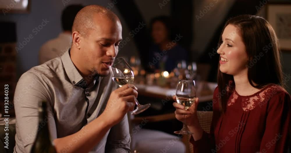 4k, Young couple in love chatting in a restaurant toasting wine glasses. 4k, Young couple in love chatting in a restaurant toasting wine glasses.