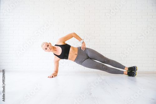 Sport woman posing in photostudio over brick wall. Fitness motivation