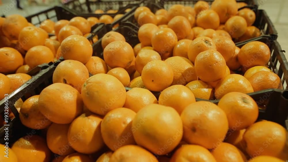 Fresh oranges in a basket in a supermarket picked from organic farm or bought from supermarket. Selective focus. Close-up. Fresh oranges in a basket in a supermarket picked from organic farm or bought from supermarket. Selective focus. Close-up.