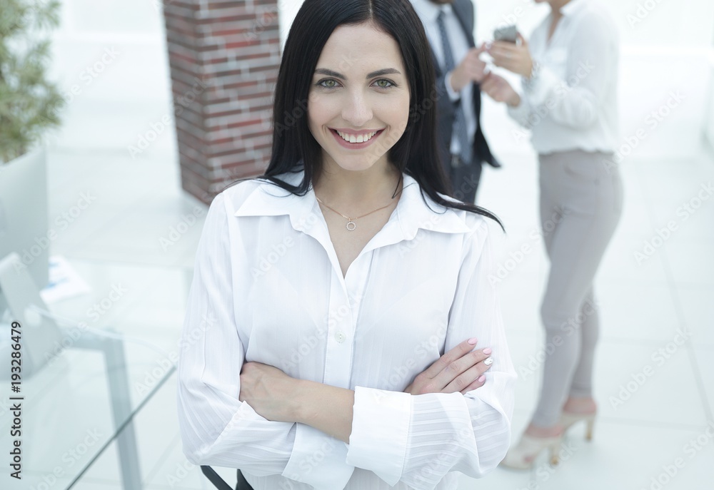 successful young business woman against the background of colleagues. successful young business woman against the background of colleagues.