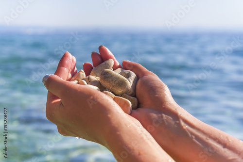 Sea pebbles in the hand.