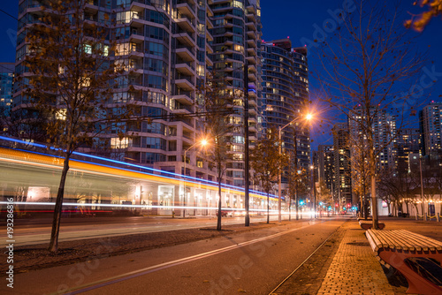 Photography Night View of a Deserted Bicycle Lane with Light Trail Left by a Tram Passing by
