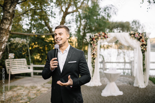 Elegant man with a microphone talking speech photo