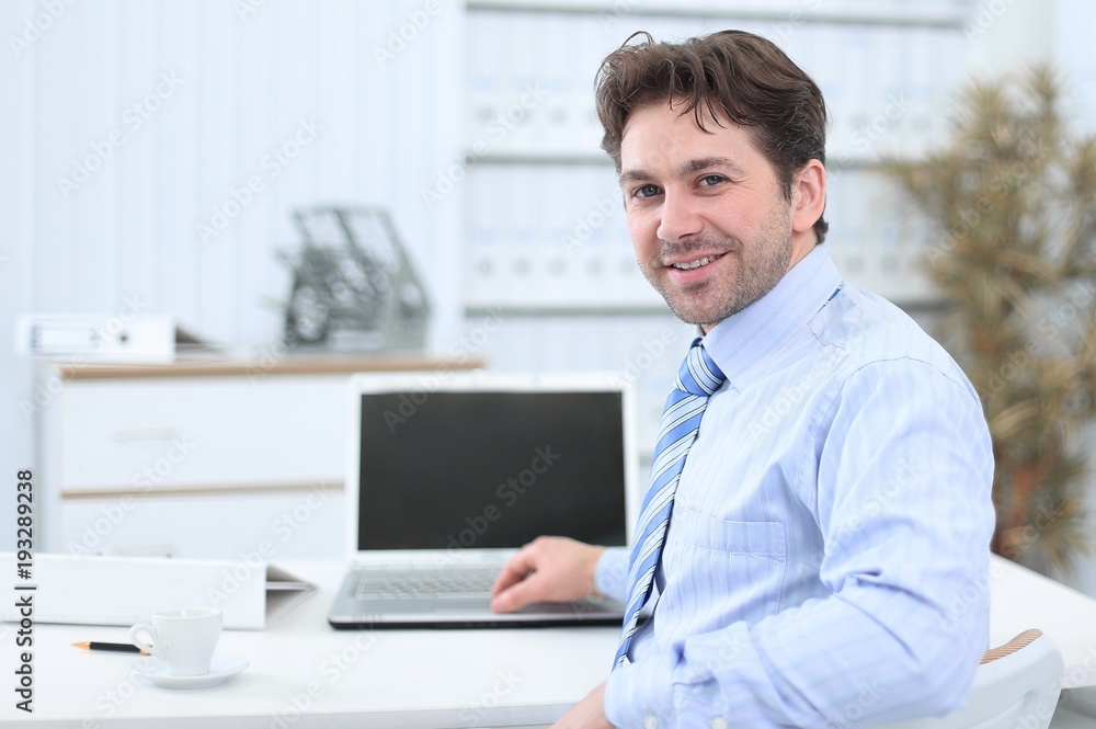 closeup.handsome businessman sitting in this Desk closeup.handsome businessman sitting in this Desk