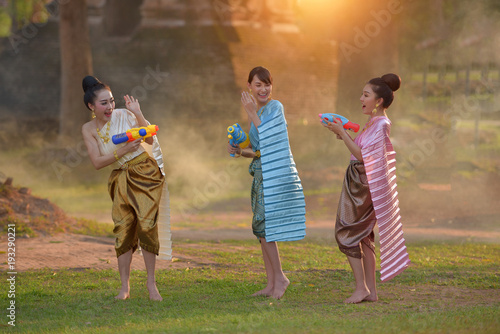 Thai girls and laos girls splashing water during festival Songkran festival