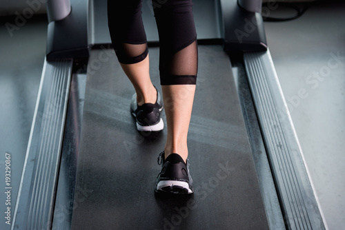 female muscular feet in sneakers running on treadmill at gym © sorapop