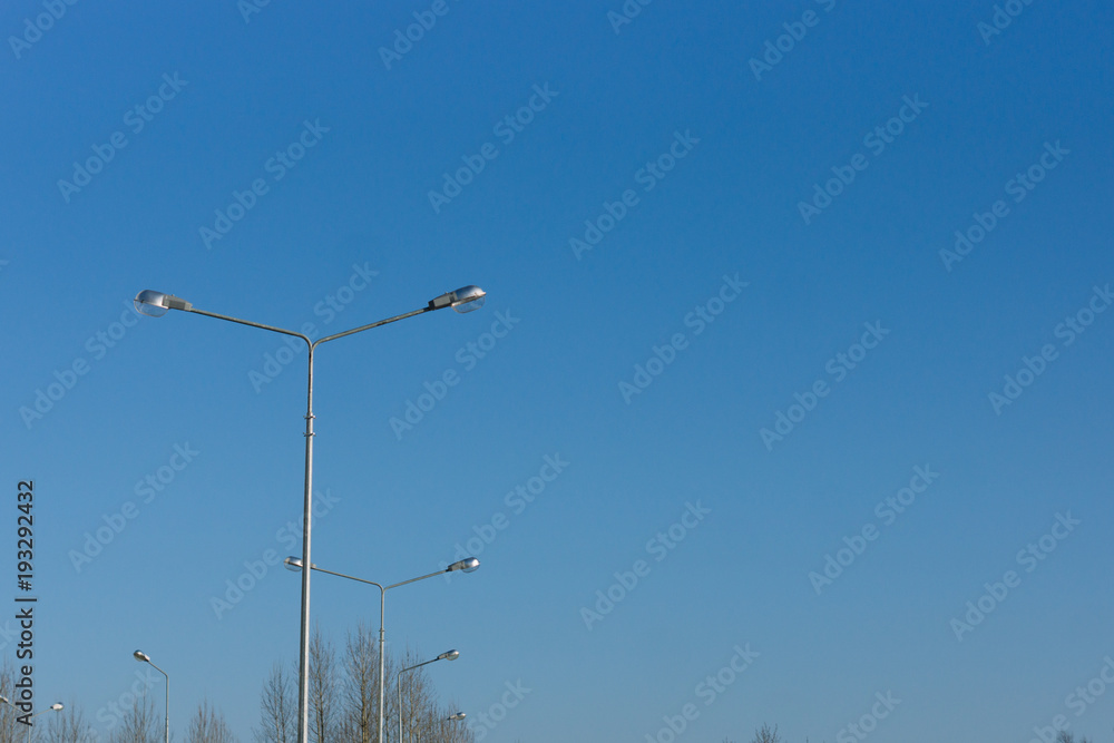 Lampposts on blue sky background. Space for text Lampposts on blue sky background. Space for text