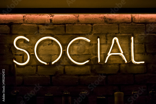 Social sign in neon yellow lights