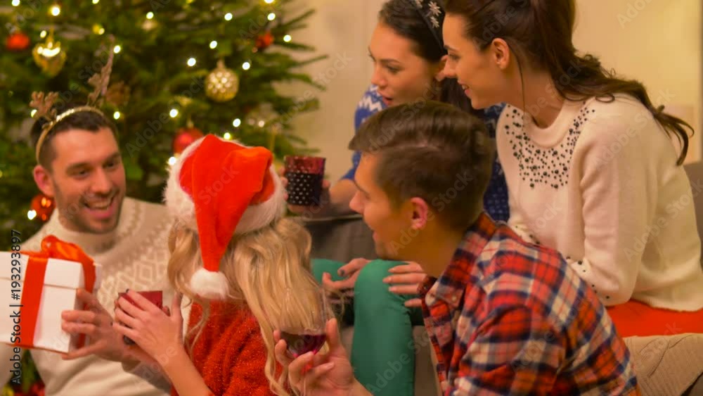 friends celebrating christmas and giving presents friends celebrating christmas and giving presents