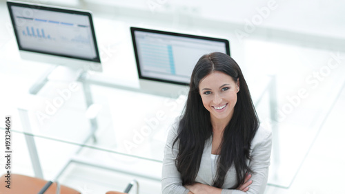 young business woman standing near modern workplace.