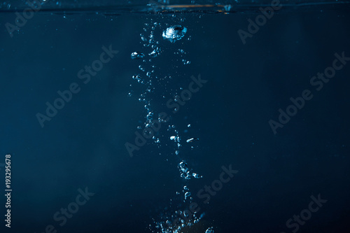 full frame of dark water with bubbles background