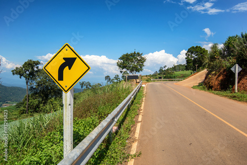 yellow sign on the road with clear sky at the way to pai , chiang mai , Thailand.