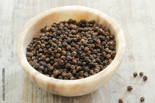 Whole Black Pepper in a marble bowl ,still life  selective focus