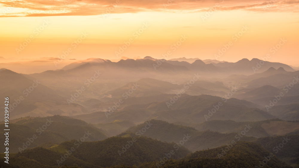 Amazing Beautiful color sunrise scenic view of mountain landscapes with layer of mountains and fog