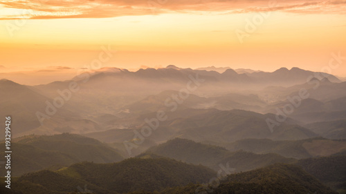 Amazing Beautiful color sunrise scenic view of mountain landscapes with layer of mountains and fog