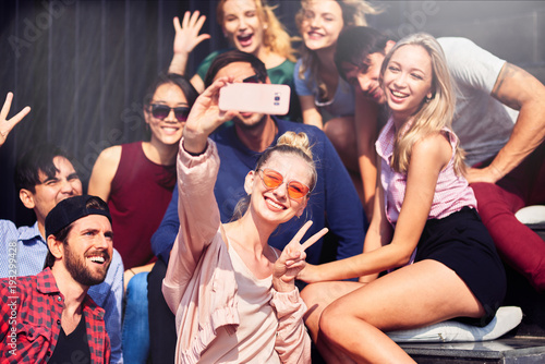 Cheerful young friends making selfies photo
